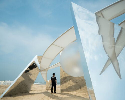 two suspended white wings float around luminous central sphere for oas/s-nest installation