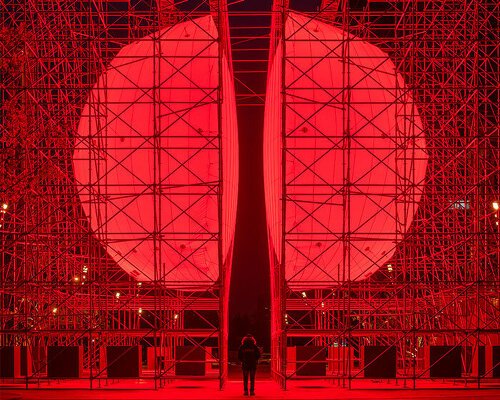 SpY’s monumental divided sphere installation illuminates xi’an in bright red light