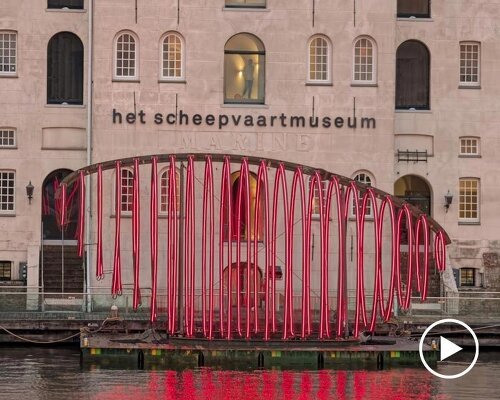 whale skeletal light installation glows red for amsterdam light festival
